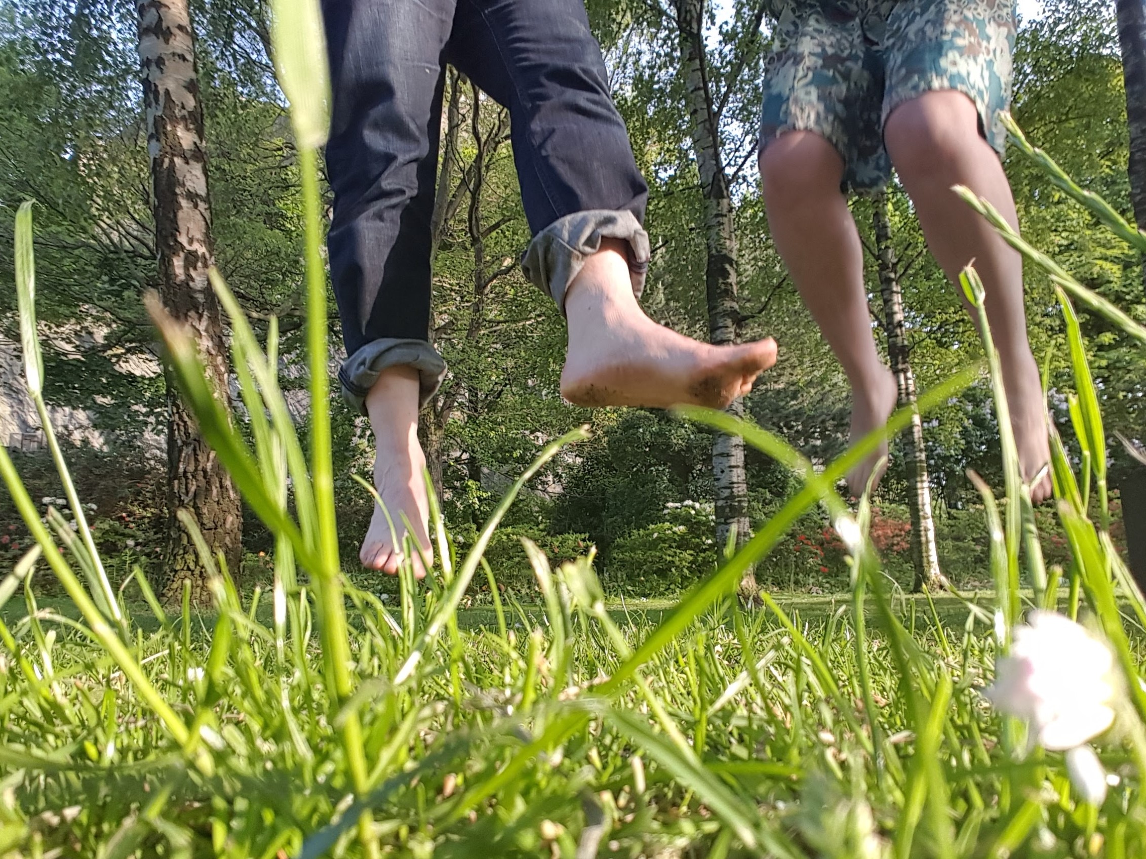 Feet jumping up and down in a field 