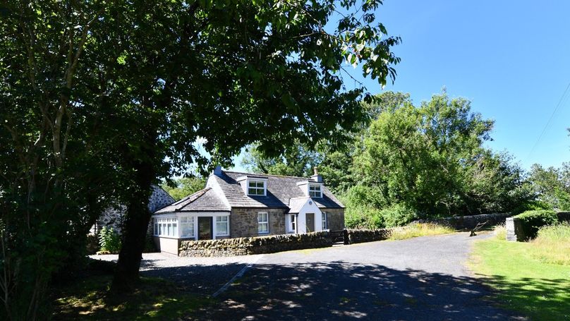 The Malzie Cottage sitting by a country road