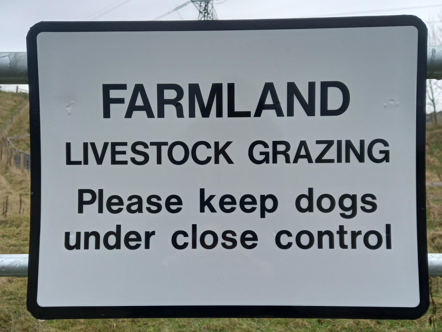 Farmland sign saying beware of dog