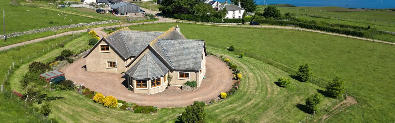 Superb sea views and wraparound garden on offer at this spacious bungalow : Fieldview Aerial 1
